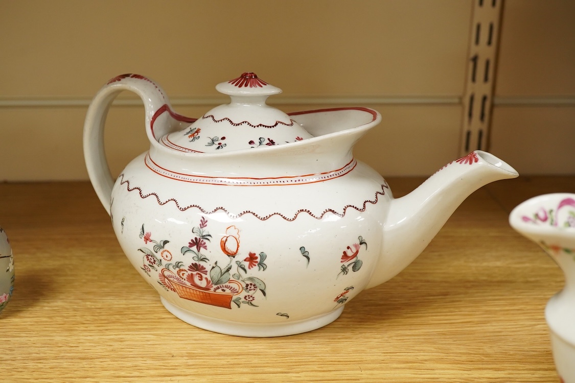 A Newhall porcelain boat shaped teapot, c.1800, together with a cream jug, tallest 14cm